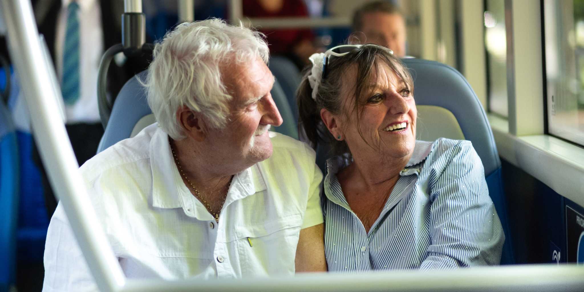 Older aged couple on the bus looking out the window